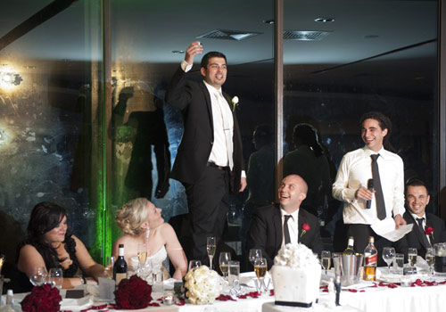 Wedding Photography of Groom toasting during speeches at Skyhigh restaurant.