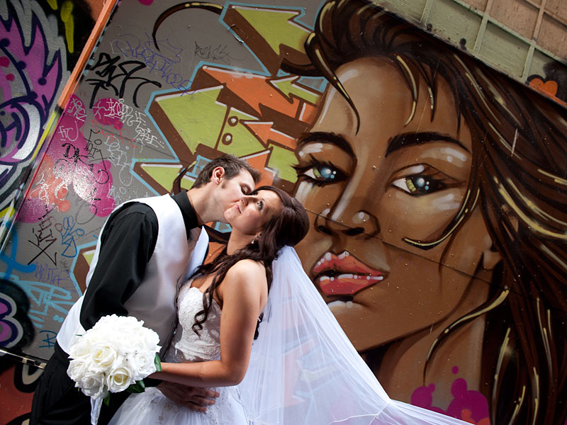 Wedding photography of newlyweds in graffiti alley